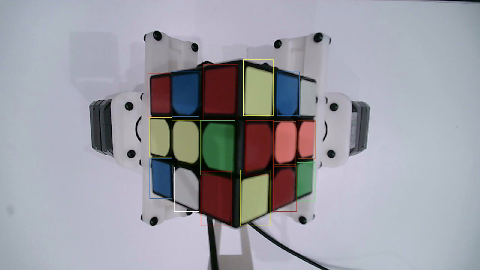 Camera frame of the cube with a coloured bounding box around every visible sticker